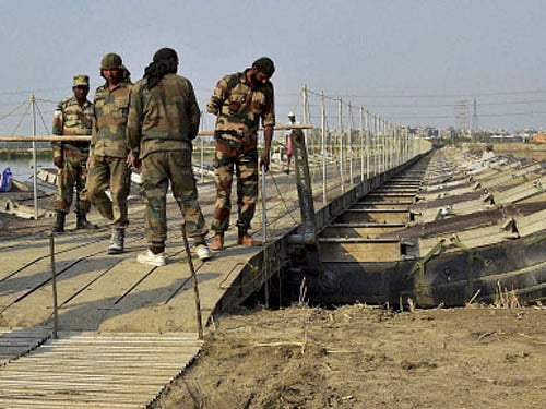 rmy personnel construct temporary bridges over Yamuna river for the three-day World Peace Festival organised by spiritual guru Sri Sri Ravi Shankar in New Delhi. PTI Photo