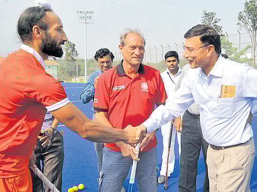 New beginning Indian captain Sardar Singh (left) greets Rajiv Yadav (right), Secretary Ministry of Youth Affairs and Sports, at the inauguration of the artificial hockey turf at SAI Centre (South). Coach of the National men's hockey side Roelant Oltmans looks on. DH photo