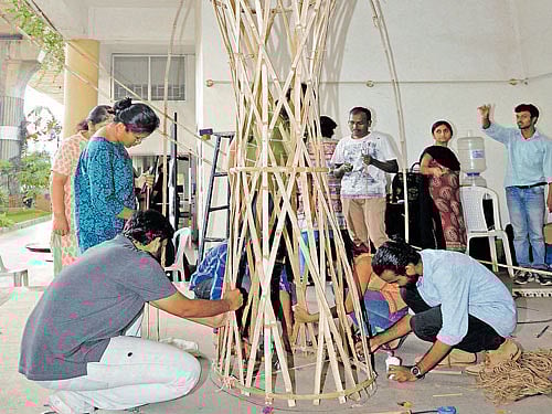 Members of the Center for Green Building Materials and Technology construct a bamboo structure at the Designguru festival in the city on Monday. DH PHOTO