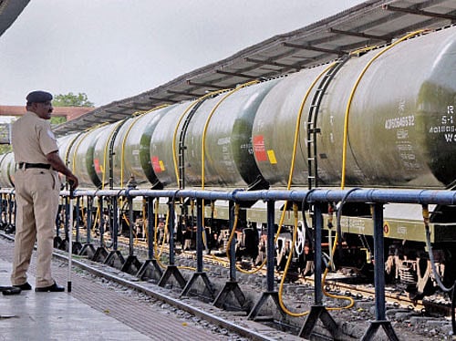 A policeman stand guards a Central Railway train loading water to transport to drought affected Latur District from Miraj station near Sangli on Sunday. PTI Photo