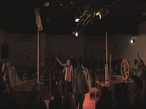 In the play, the actors set off across the Mediterranean first to Greece, then Italy, Spain, France, Britain and Germany, with only a map of Europe and a telescope, hoping one of those countries will take them in. Screen grab.