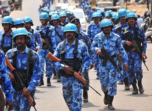 Rapid Action Force personnel today staged a flag march along the Jalahalli Cross stretch, one of the worst-hit by the violence yesterday, even as police arrested about 50 persons in connection with the untoward incidents. DH File Photo