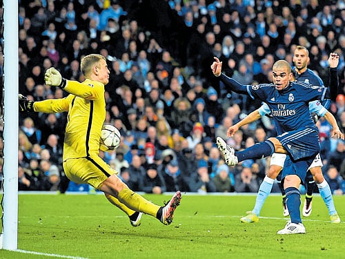 sensational show: Manchester City's Joe Hart (left) denies Real Madrid's Pepe with an excellent save during their Champions League semifinal first leg on Tuesday. AFP
