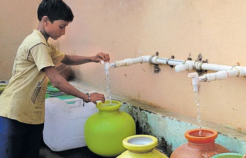 Aim to improve: An AquaSafi unit in Gadag-Betagari; (below) an SMS from NextDrop.