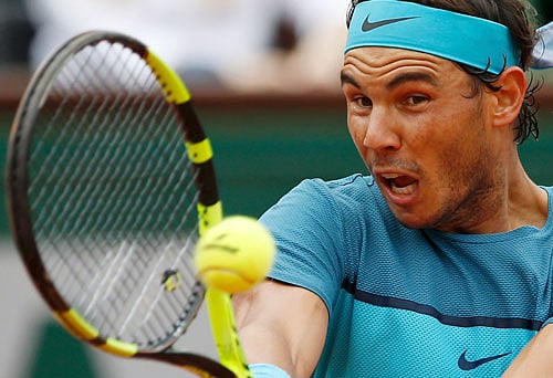 Milestone Man: Spain's Rafael Nadal plays a forehand return en route his 6-3, 6-0, 6-3 thrashing of Facundo Bagnis on Thursday. It was Nadal's 200th win in Grand Slams. Reuters