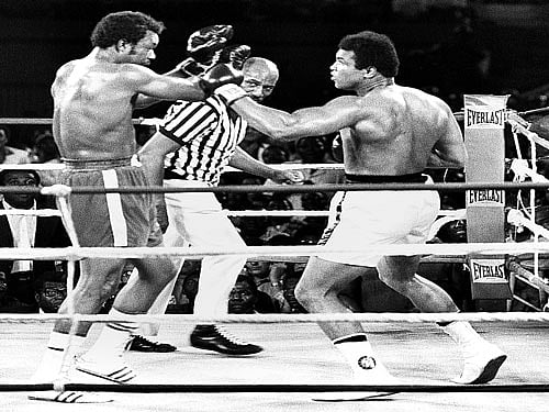 Ali tackles George Foreman in the fight known as the Rumble in the Jungle.