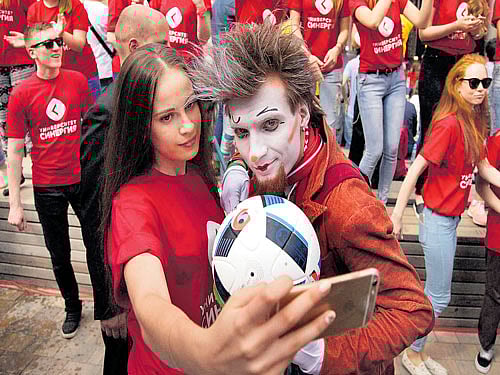 Volunteers take a selfie at the recent launch of FIFA's World Cup Volunteers Programme in Moscow. Smartphones have triggered a deluge of photos, prompting many companies to offer tools to manage them. AP/PTI