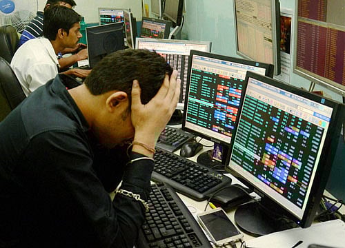 Share brokers react to falling stock prices on screens of computers and television in Kolkata on Friday. BSE Sensex plunged down nearly 1000 points and NSE Nifty fell down below 7,950 following Brexit. PTI Photo