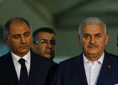 Turkey's Prime Minister Binali Yildirim speaks to the press next to the Interior Minister Efkan Ala at the Ataturk airport in Istanbul. Reuters photo