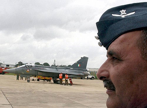 An officers watches as the Light Combat Aircraft (LCA) Tejas is inducted into the 45 Squadron (flying dagger) of the IAF at a ceremony, at HAL (ASTE) in Bengaluru on Friday. PTI Photo