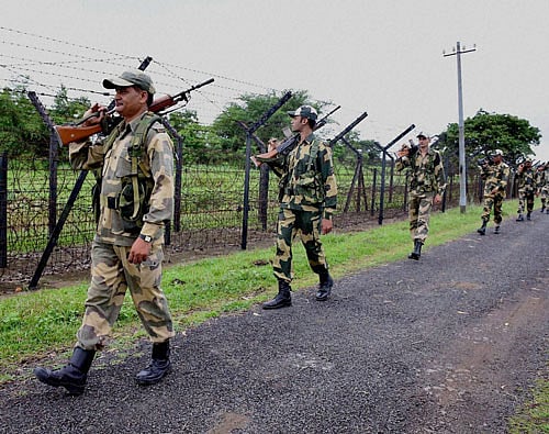 Border Security Force (BSF) personnel keep vigil along the India-Bangladesh Border at Shivrampur near Balurghat in South Dinajpur District of West Bengal on Sunday. The security has been beefed up in the region after the Friday's terror attack at Dhaka Cafe. PTI Photo