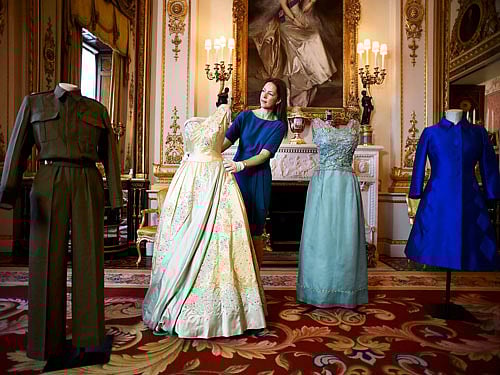 Exhibition curator Caroline de Guitar poses for photographers as she shows off a preview of an exhibition entitled 'Fashioning a Reign: 90 Years of Style from The Queen's Wardrobe,' charting the reign of Britain's Queen Elizabeth through a display of her formal and informal outfits, at Buckingham Palace, in central London. REUTERS Photo