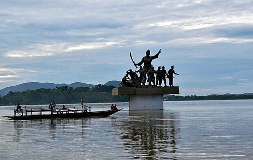 A passenger ferry passes by Bir Lachit Barphukan Statue on the flooded Brahmaputra River in Guwahati on Saturday. PTI Photo
