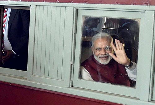 Prime Minister Narendra Modi waves from train at Pietermaritzburg Railway Station on Saturday. PTI Photo