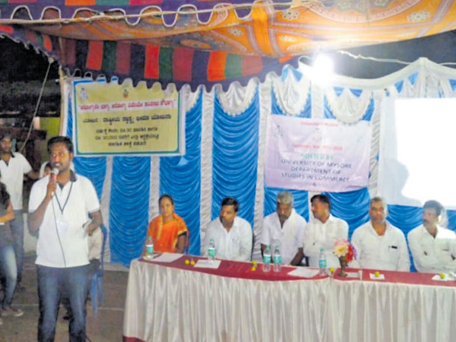 Student volunteers of MAEM enrol residents for insurance schemes at a village. Photo by special arrangement