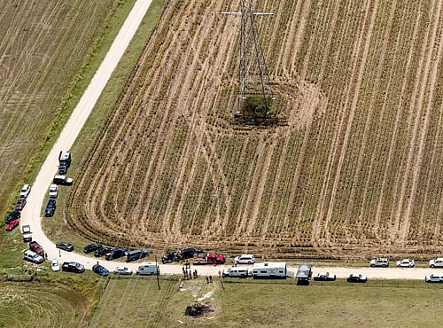 Law enforcement officers examine the scene of a hot air balloon crash that killed 16 people in Maxwel. Reuters photo