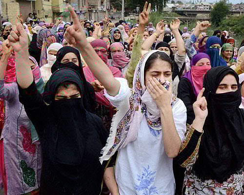 Girls shout slogans during a protest march in Barzulla area of  Srinagar on Tuesday. PTI