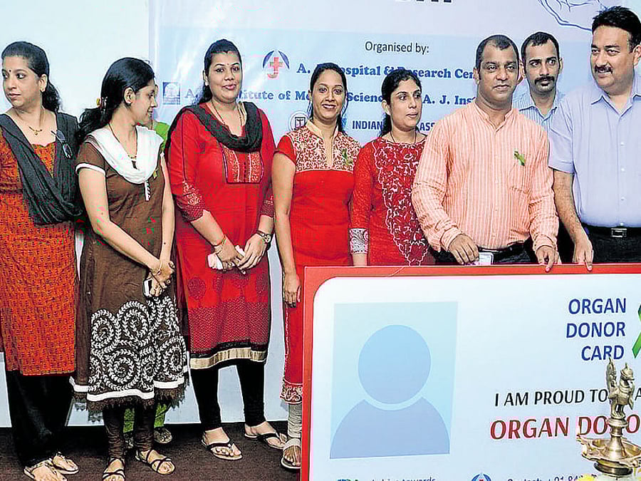 A J Hospital and Research Centre Medical Director Dr Prashanth K Marla distributes organ donor card, on account of World Organ Donation Day, in Mangaluru on Saturday.