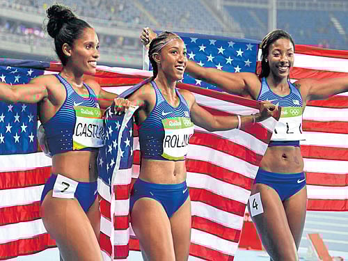 girl power Brianna Rollins (centre), Nia Ali (right) and Kristi Castlin celebrate a US 1-2-3 in the women's 100M hurdles on Wednesday. dh photo