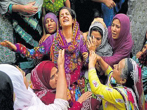 in mourning: Relatives wail over the death of Irfan Fayaz Wani (19), who was hit by a tear gas shell during a clash on Sunday night, in Srinagar on Monday. PTI