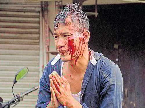 save me: An injured member of the Indigenous People's Front of Tripura pleads to be rescued during clashes in Agartala on Tuesday. PTI