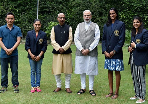 Prime Minister Narendra Modi and sports Minister Vijay Goel pose with Olympic Medal Winners, Khel Ratna Awardees in New Delhi on Sunday. The players are silver medallist shuttler P V Sindhu (2R) bronze medal winning wrestler Sakshi Malik (R), gymnast Dipa Karmakar (2L) and ace shooter Jitu Rai (L). PTI Photo