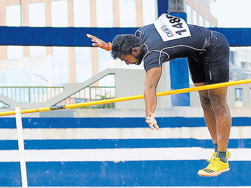 fine effort: Balakrishnan P soars to new record en route to the men's pole vault gold in the State Senior and Junior athletics meet on Saturday. dh photos/srikanta sharma r