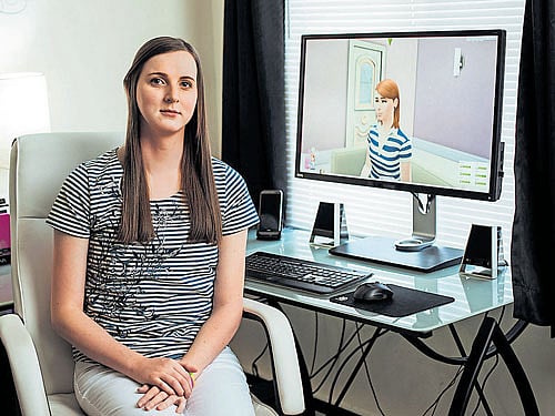 Blair Durkee, with her transgender Sims character, Amber, in the background, in her apartment in Central city, South Carolina, USA. INYT