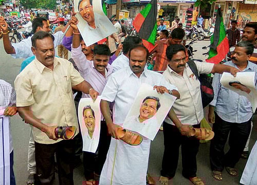 Volunteers and functionaries of different Tamil outfits stage a demonstration at the Puducherry branch of Karnataka Bank Limited on Monday to protest against the Karnataka government's refusal to release Cauvery water for Tamilnadu. PTI Photo