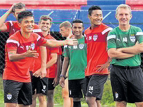 Bengaluru FC skipper Sunil Chhetri (left) shares a lightmoment with head coach Albert Rocca during a training session on the eve of their tie. DH PHOTO/ SRIKANTA SHARMA R