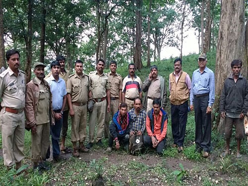 The three men (sitting) who lost their way in the deep forests of Nagargali in Khanapur taluk, Belagavi district, during a trip to a small waterfall on Sunday. They were rescued on Monday. DH&#8200;PHOTO
