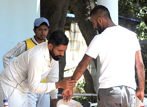 Nice one mate: Robin Uthappa (left) checks out KL Rahul's tattoo during Karnataka's training session at the RSI ground on Thursday. DH PHOTO