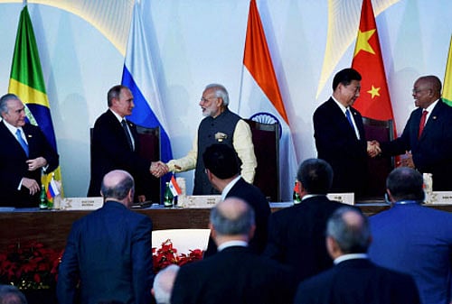 Prime Minister Narendra Modi, Brazilian President Michel Temer, Russian President Vladimir Putin, Chinese President Xi Jinping and South African President Jacob Zuma shake hands after the press statement during BRICS Summit in Benaulim, Goa on Sunday. PTI Photo