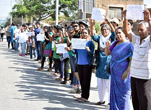 People take out a protest march against the steel flyover project in Bengaluru on Sunday. dh Photos / s k dinesh and b k janardhan