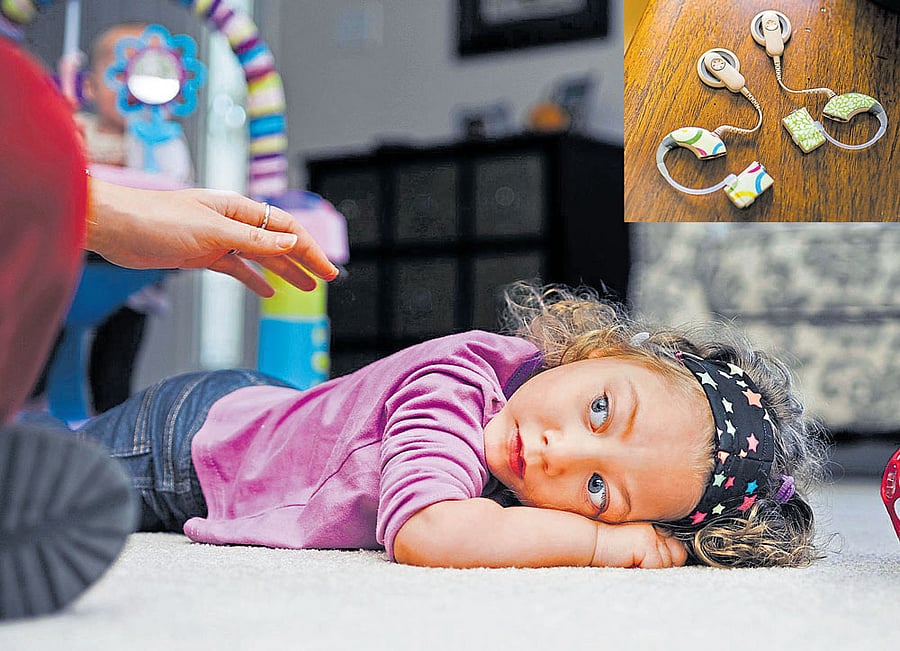 ignorance no bliss: Evelyn Steadman, who was born with the cytomegalovirus, has microcephaly and deafness. Every year, 40,000 infa-nts are born with CMV in the US, but very few doctors tell pregnant patients how to avoid getting infected by it. (inset: cochlear implants). NYT