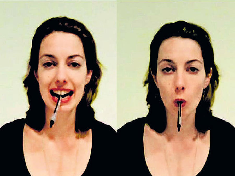 FACIAL CUES Holding a pen between the teeth induces a smile while holding it between the lips induces a pout or frown. PHOTO CREDIT: E-J Wagenmakers et al
