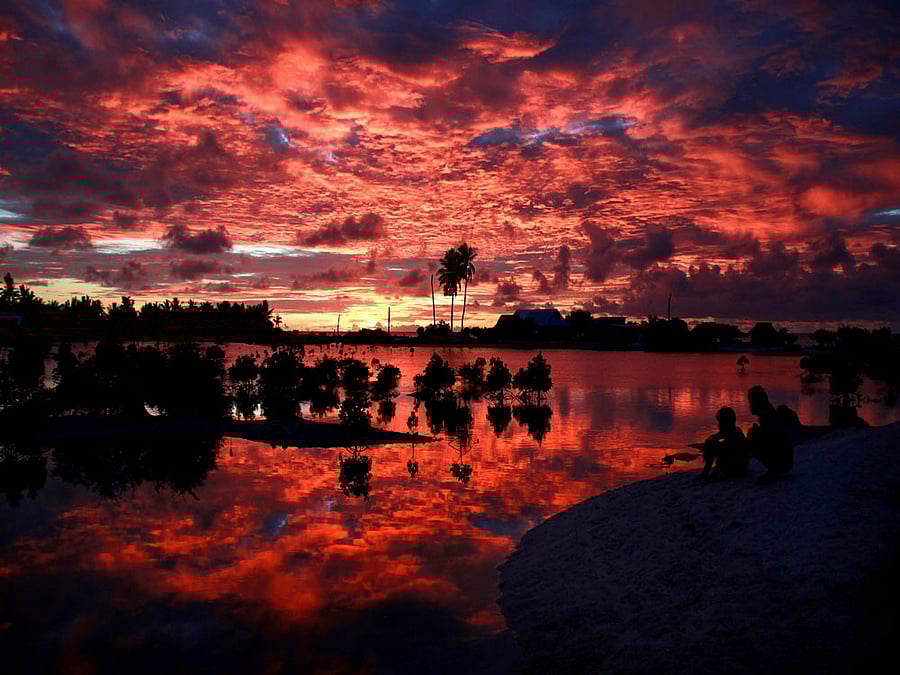 Villagers watch the sunset over a small lagoon near the village of Tangintebu on South Tarawa in the central Pacific island nation of Kiribati. Reuters file photo