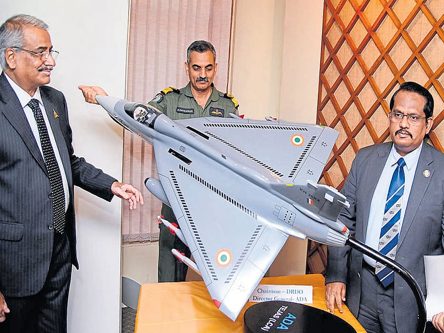 Air Cdre C D Balaji (retired), director of the Aeronautical Development Agency; J A Maolankar, chief test pilot of the National Flight Test Centre; S Christopher, director general of DRDO, look at a model of the light combat aircraft Tejas at a press conference in Bengaluru on Sunday. dh photo