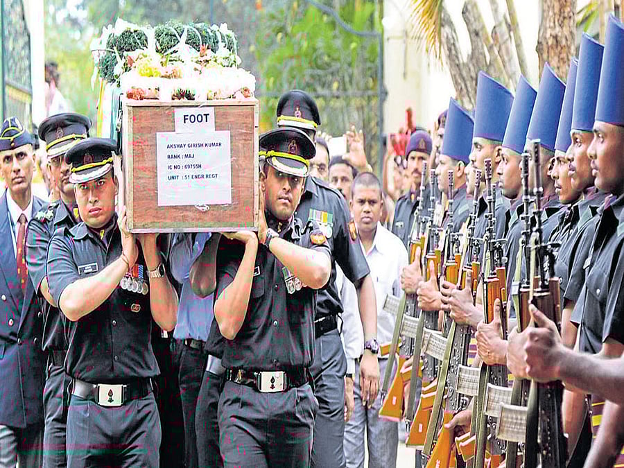 Army men bring Major Akshay Girish Kumar's mortal remains to his house at Sadahalli near the Kempegowda International Airport in Bengaluru on Thursday. DH Photo / Srikanta Sharma R