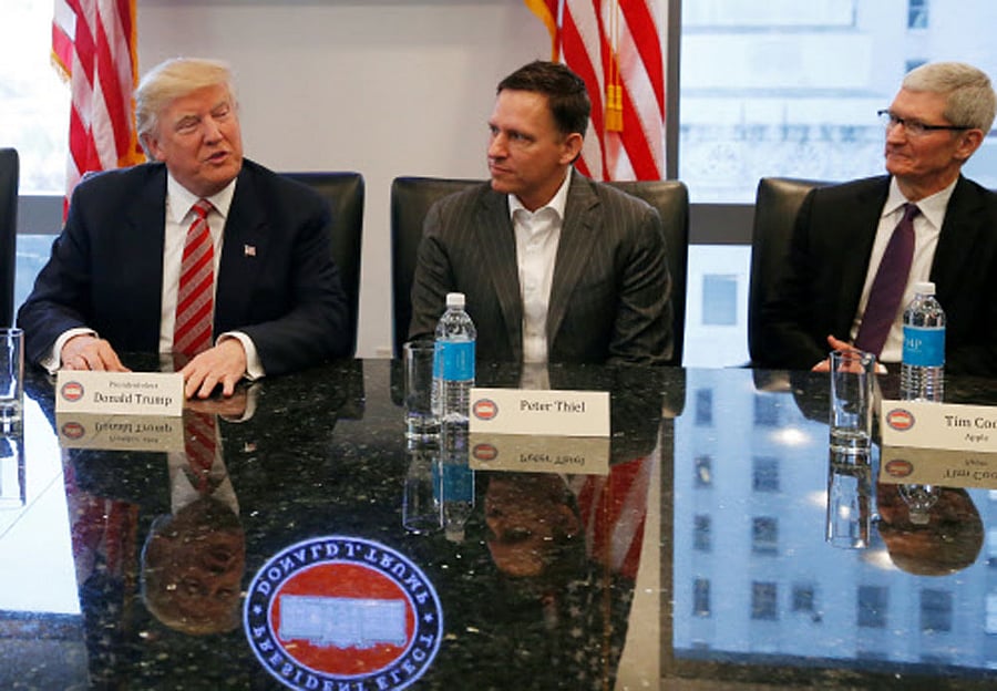 U.S. President-elect Donald Trump speaks while PayPal co-founder and Facebook board member Peter Thiel and Apple Inc CEO Tim Cook look on during a meeting with technology leaders at Trump Tower in New York. Reuters