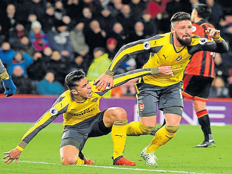 HERE WE COME! Arsenal's Olivier Giroud (right) celebrates after scoring against Bournemouth. REUTERS