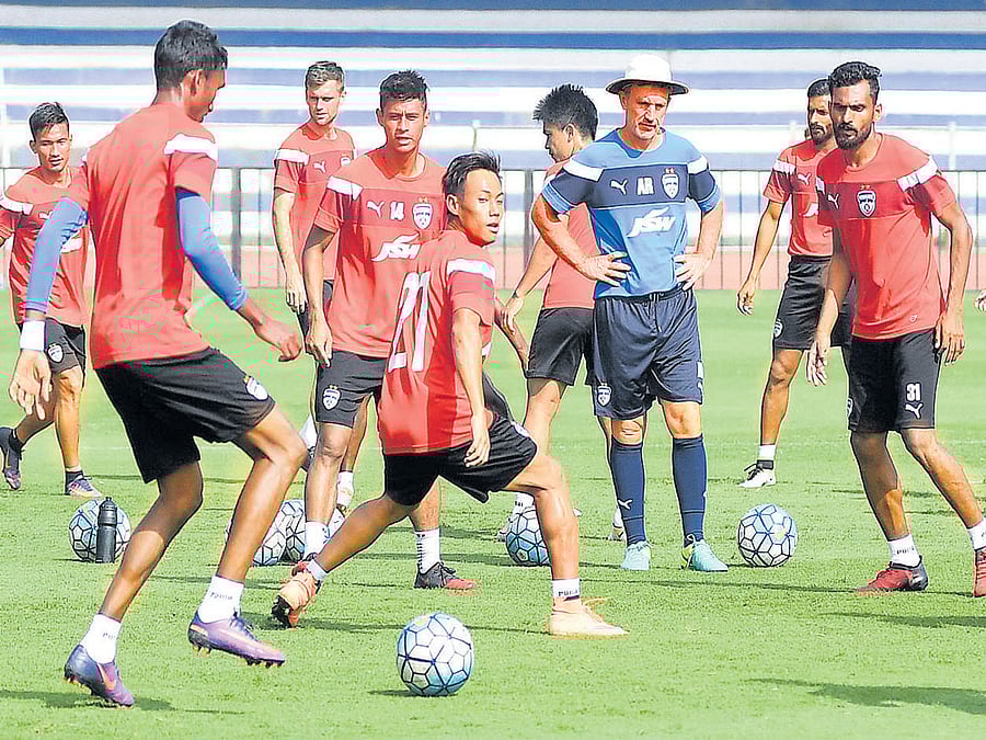 training hard: Bengaluru FC players train under the watchful eyes of coach Albert Roca (in hat) ahead of their opening I-League clash against Shillong Lajong at the Sree Kanteerava Stadium on Saturday. DH PHOTO/ KISHOR kumar bolar