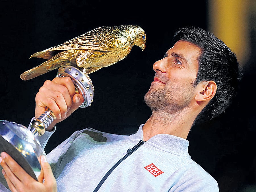 You're beautiful! Serbia's Novak Djokovic admires his Qatar Open prize after defeating his great rival Andy Murray in the final at Doha on Saturday night. afp