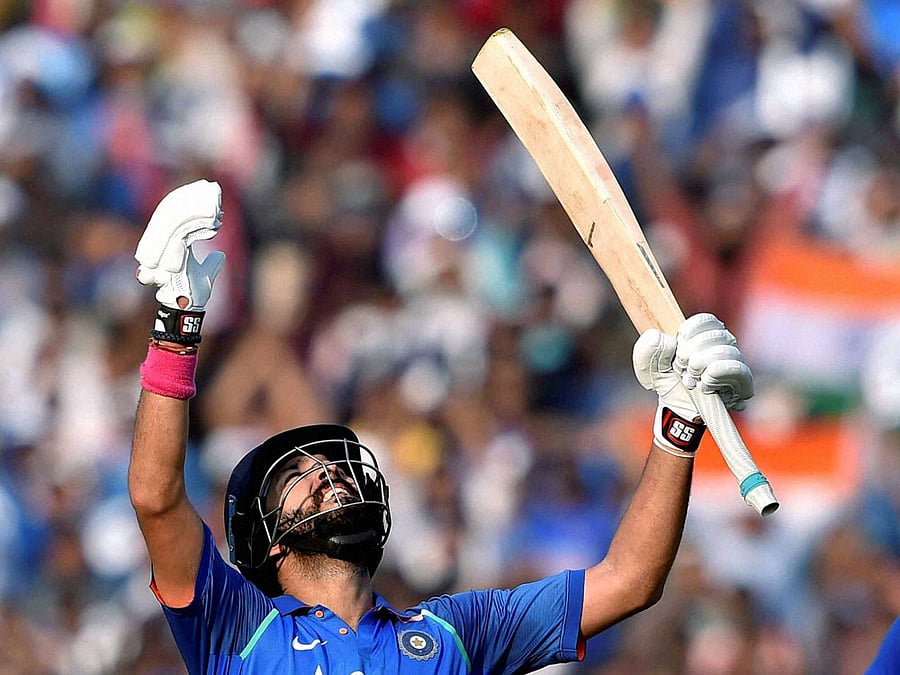 Indian batsman Yuvraj Singh celebrates his century during 2nd ODI Match against England at Barabati Stadium in Cuttack on Thursday. PTI Photo
