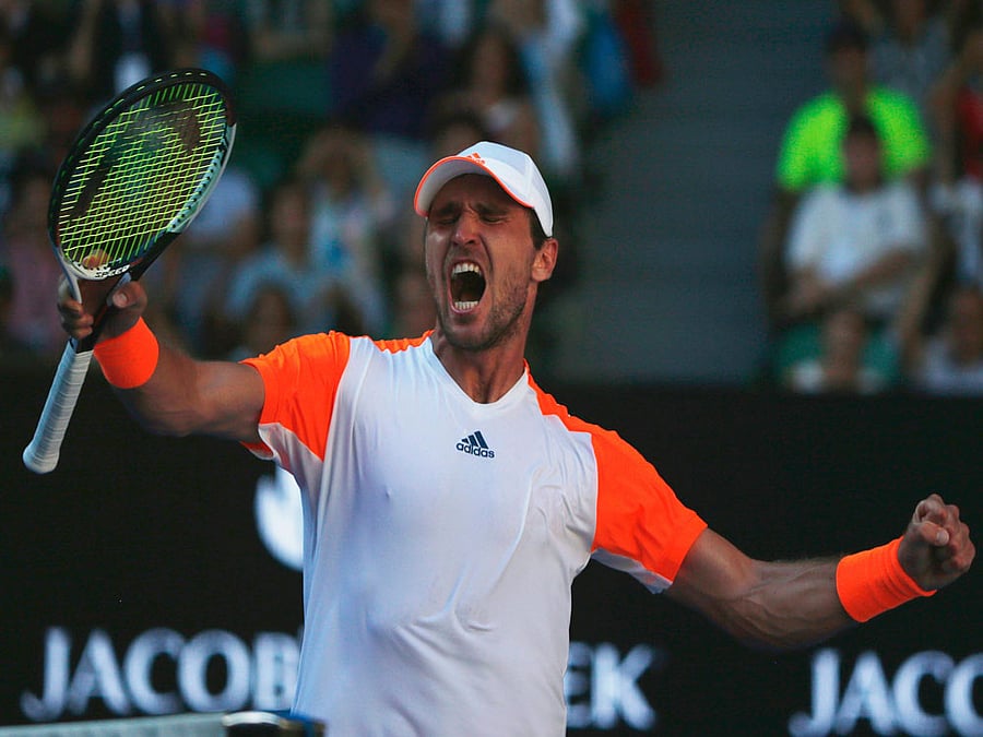 Germany's Mischa Zverev celebrates after winning his Men's singles fourth round match against Britain's Andy Murray. REUTERS