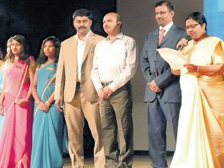 IGNITING MINDS Faculty members and students on stage.