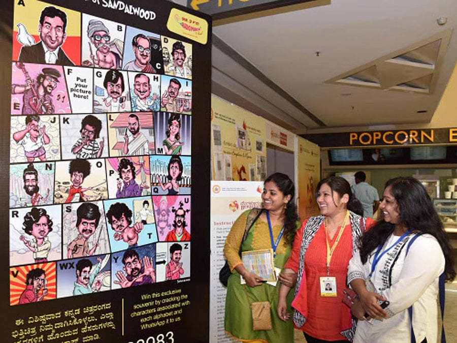Visitors look film stars poster at 4th day at Bengaluru International Film Festival (Biffes) organised by Information Department and Karnataka Chalanachitra Academy at PVR cinemas Orion Mall in Bengaluru on Monday. DH Photo.