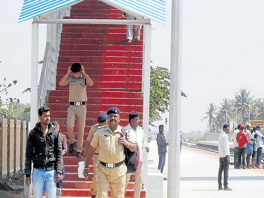 Railway police arrive at Hiresave station to arrest three persons who instigated villagers to place boulders on tracks near Mallaghatta in Kunigal taluk of Tumakuru district on Thursday.