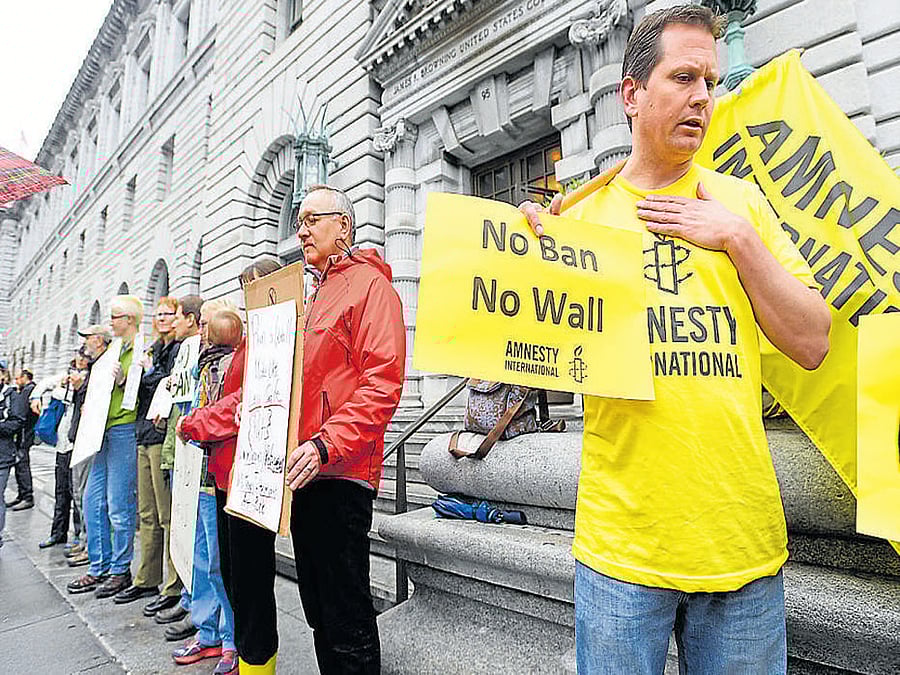 Protesters outside a court in San Francisco after it heard  arguments regarding Trump's travel ban. REUTERS