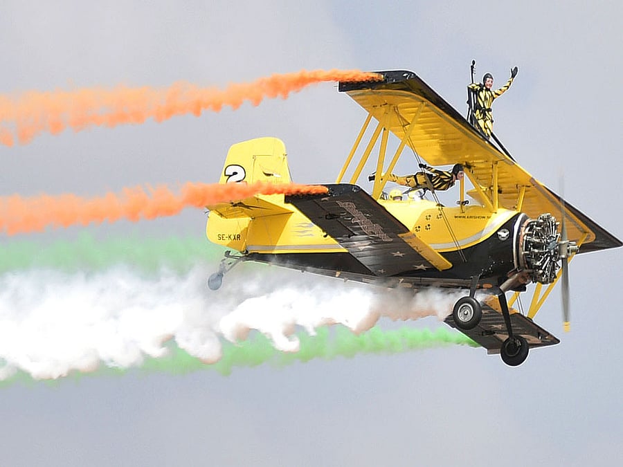 'Flying cats' showcase mid-air aerobatic skills during the inauguration of 11th edition of Aero India 2017 at Yelahanka Airbase in Bengaluru on Tuesday. DH Photo by B K Janardhan